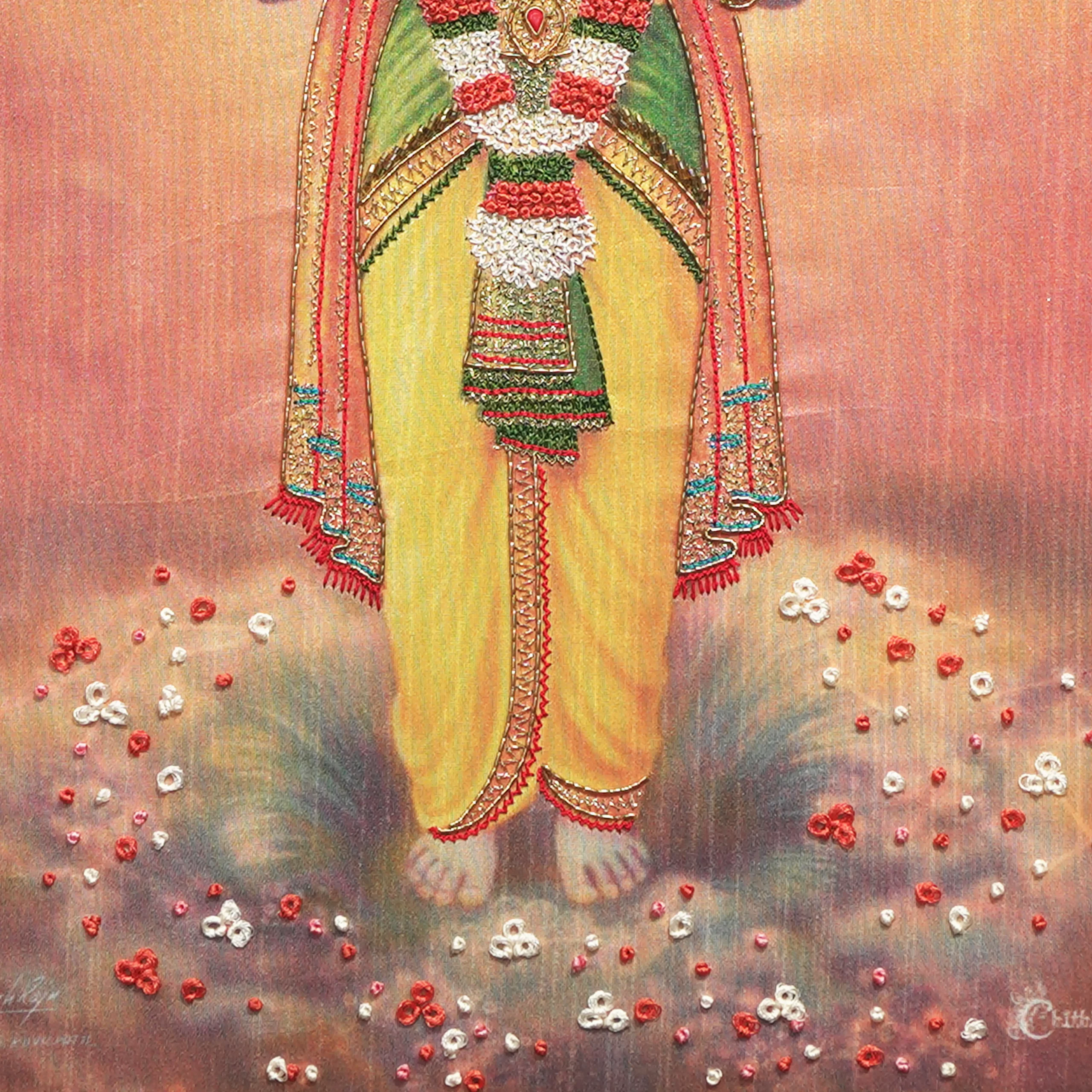 Close-up of Lord Dhanvantri lower body embroidery showing intricate Zardoshi threadwork on raw silk
