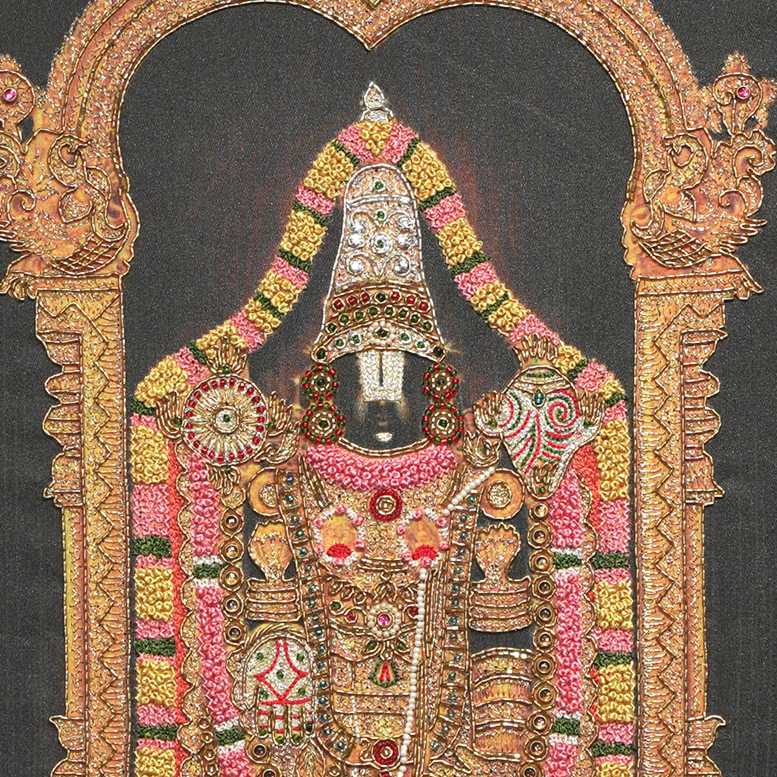 Close-up of Lord Venkatachalapathy face and crown detail with handcrafted Ari and Zardoshi embroidery on raw silk