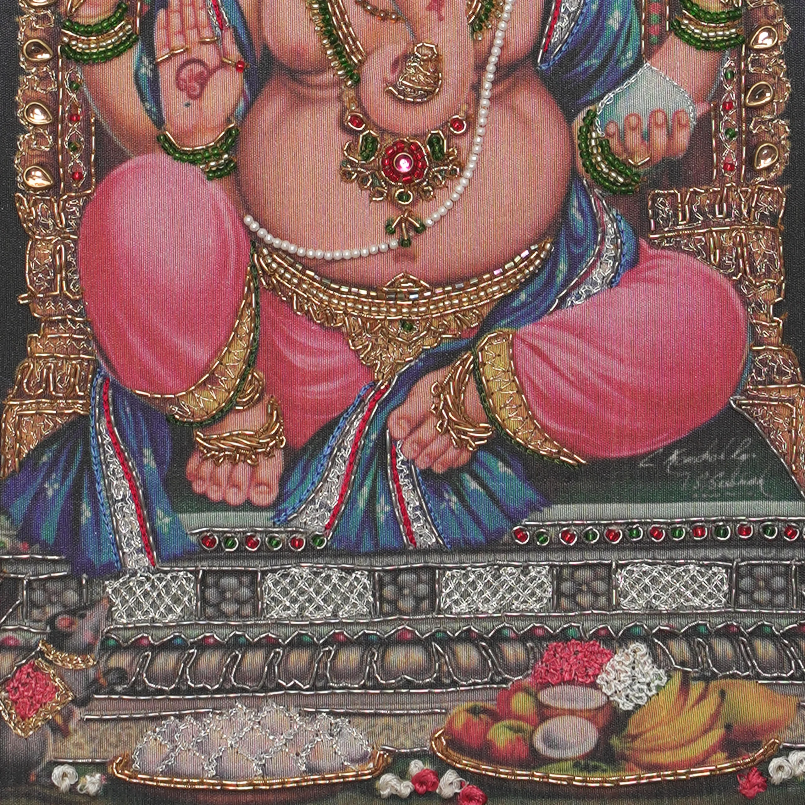 Close-up of Lord Vigneshwarar lower body embroidery showing intricate Zardoshi threadwork on raw silk