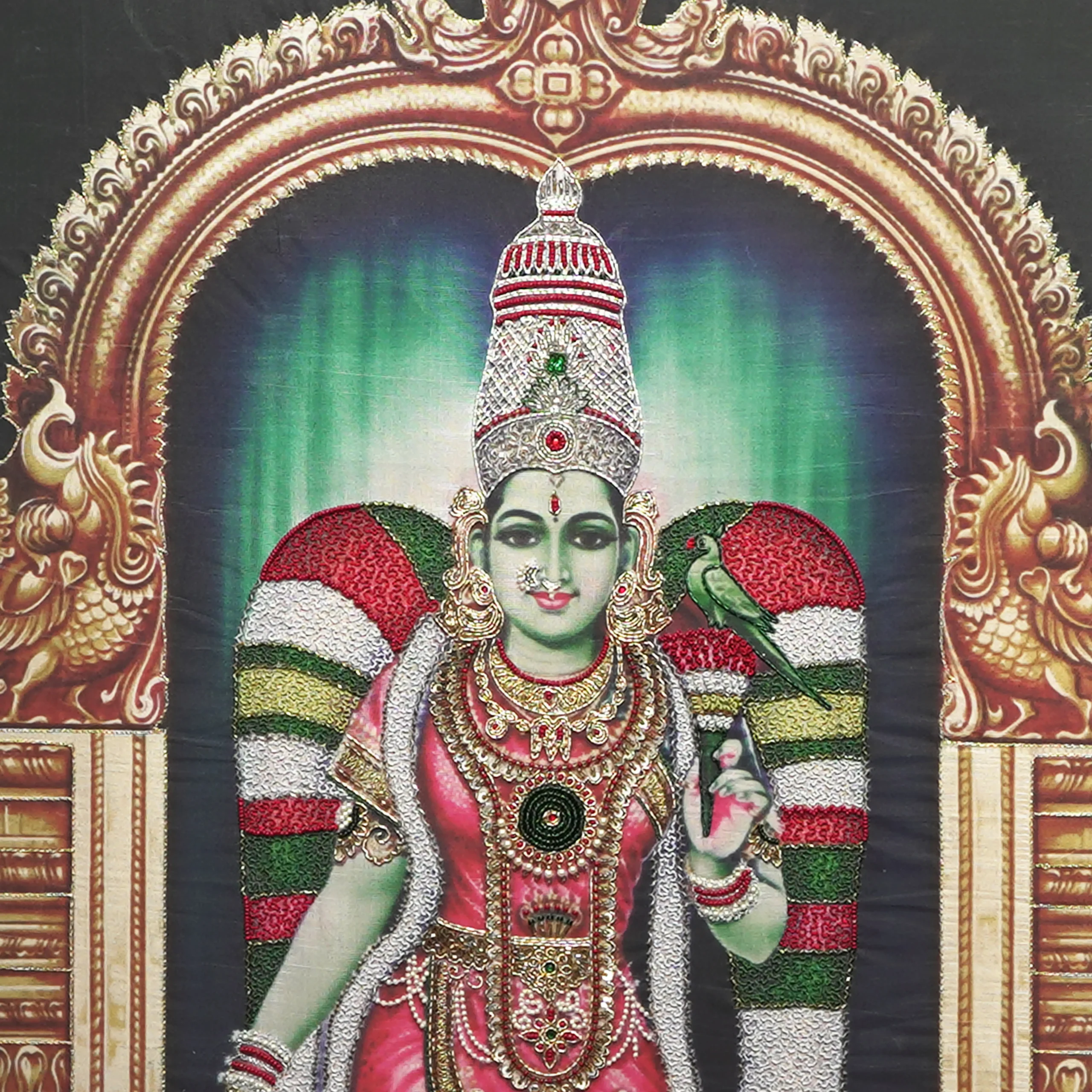 Close-up of Sri Meenakshi face and crown detail with handcrafted Ari and Zardoshi embroidery on raw silk