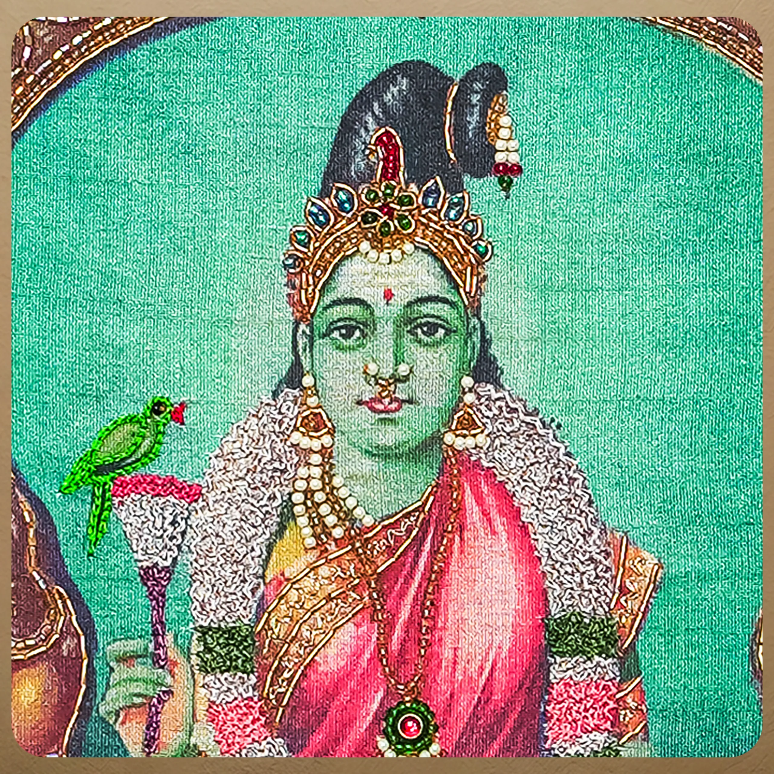 Close-up of Sri Meenakshi face and crown detail with handcrafted Ari and Zardoshi embroidery on raw silk